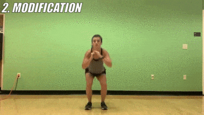 female demonstrating modified deep squat to lateral leg lift