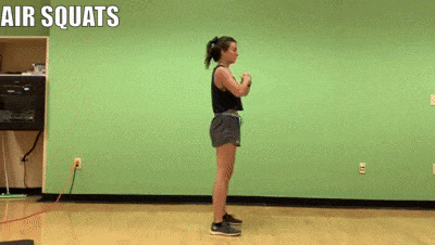 female demonstrating air squats