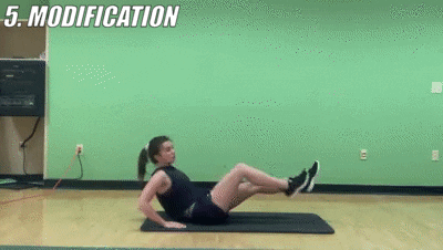 woman demonstrating modified bicycle rotations for 12-15 reps