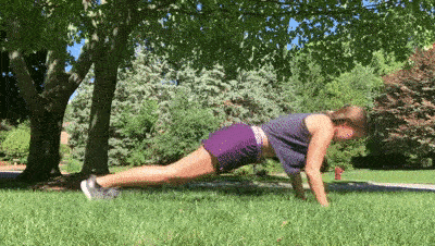 female demonstrating pushup with plank jack