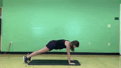 female demonstrating modified bear to plank