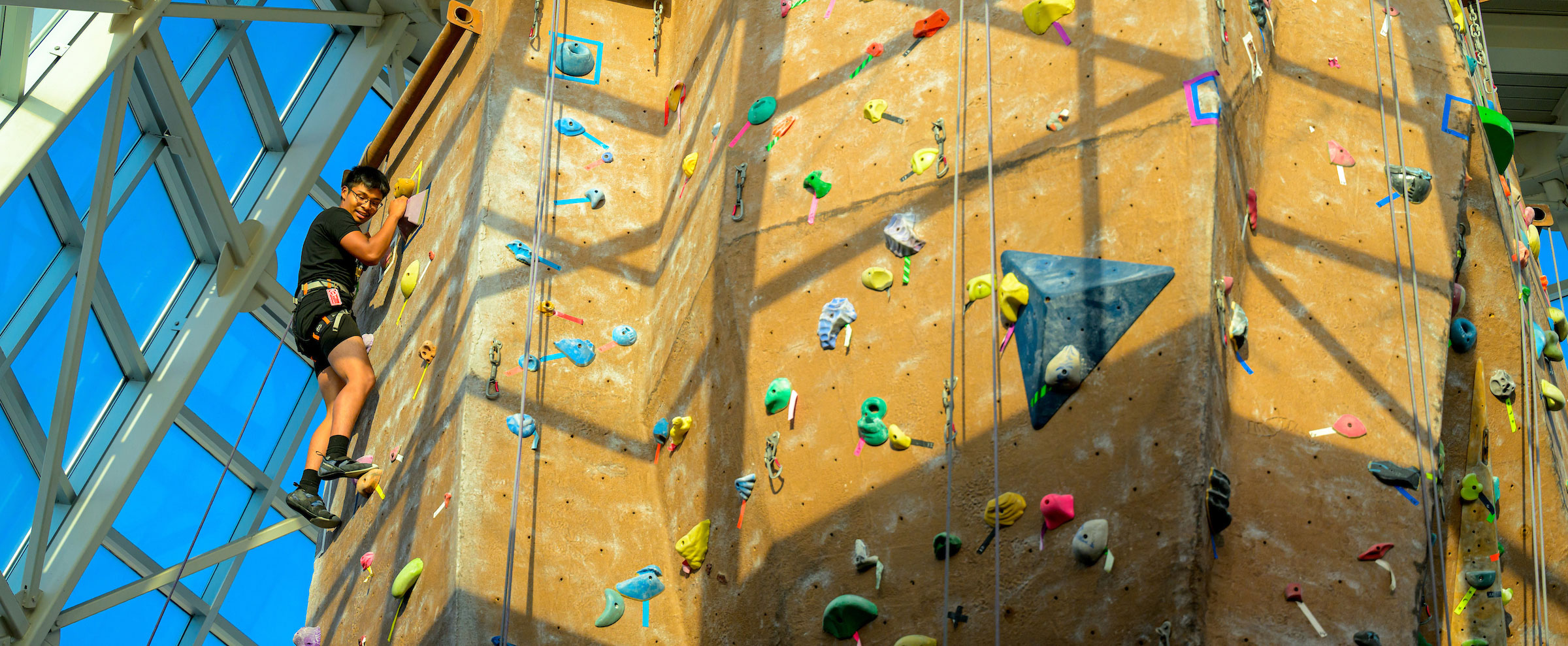 person climbing rock wall