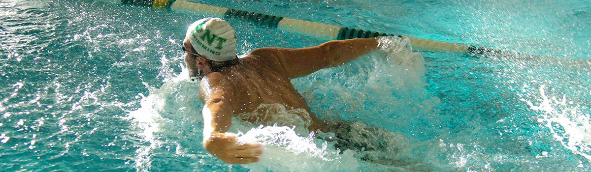 A UNT swimmer rushes through the water