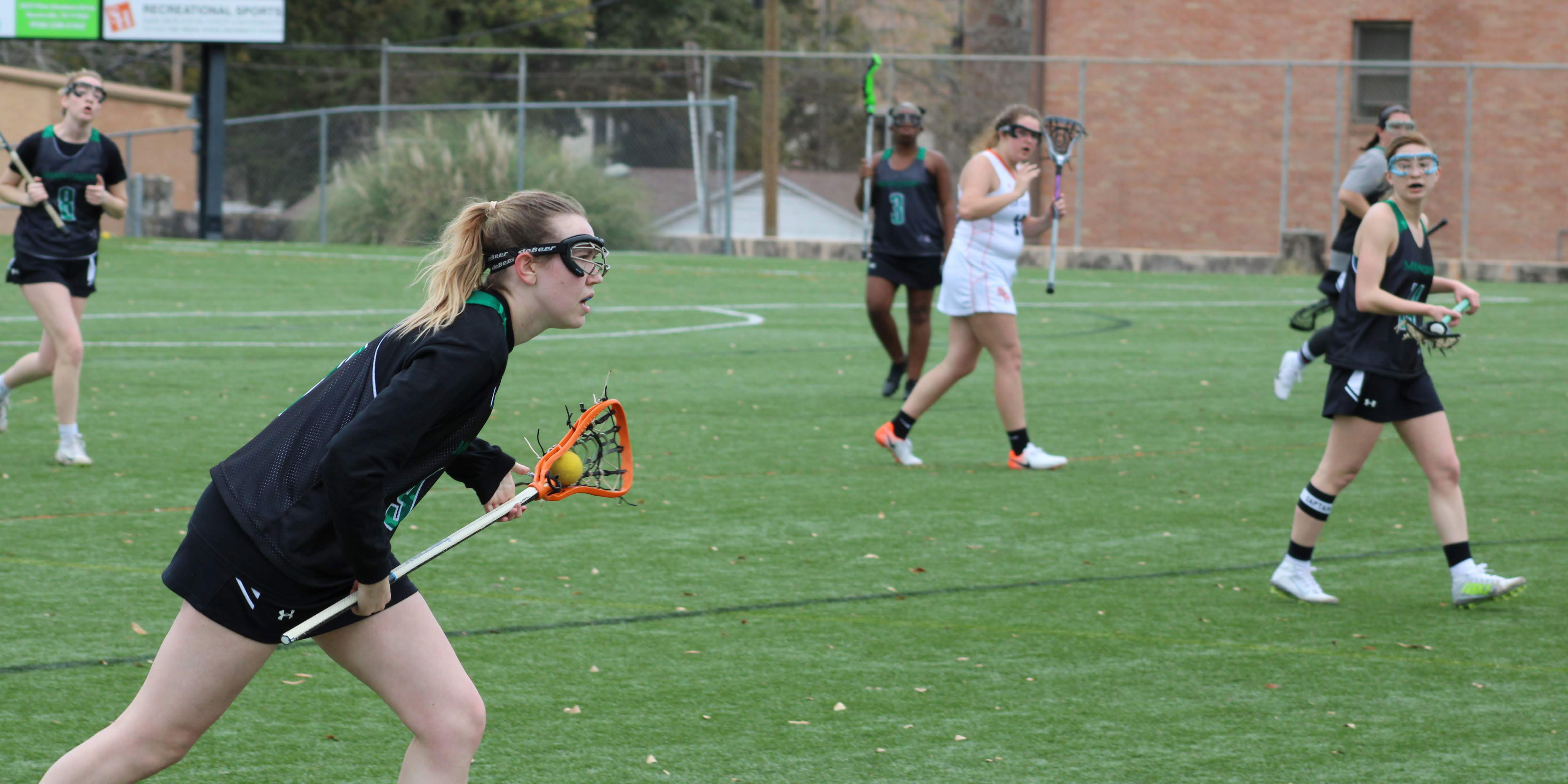 The women's lacrosse team takes the field.