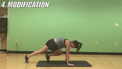 woman demonstrating modified cross-body mountain climbers