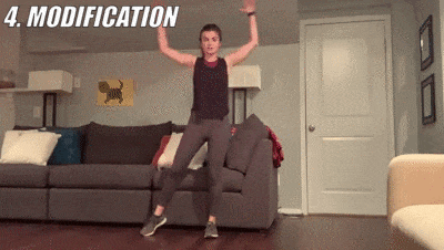 woman demonstrating modified jumping jacks