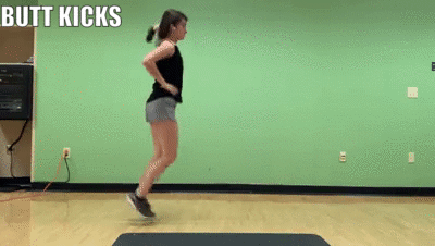 woman demonstrating butt kicks