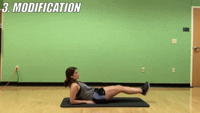 woman demonstrating modified lying knee tuck
