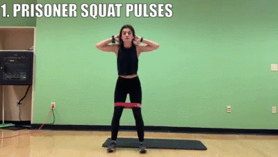 woman demonstrating prisoner squat pulses