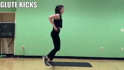 woman demonstrating glute kicks
