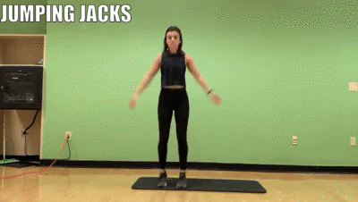 woman demonstrating jumping jacks