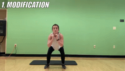 woman demonstrating modified squat jumps