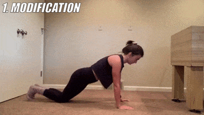 woman demonstrating modified pushup to ankle tap