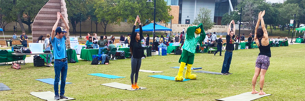 fitness participants practicing yoga on union lawn