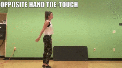 female demonstrating opposite hand-toe touch
