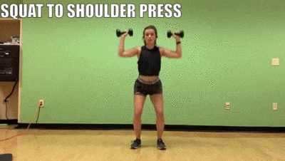 female demonstrating squat to shoulder press