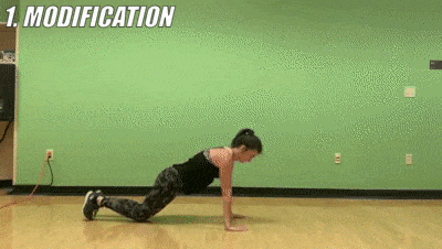 woman demonstrating modified push up taps