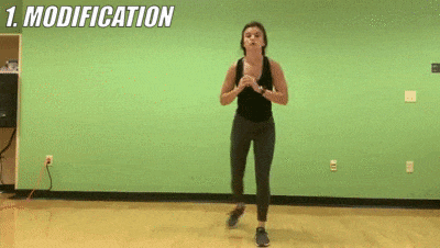 woman demonstrating modified reverse lunge to squat jump