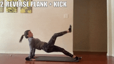 woman demonstrating reverse plank + kick