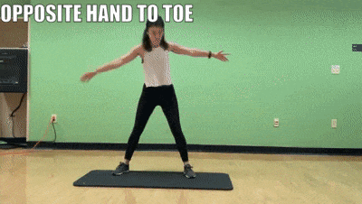woman demonstrating opposite hand to toe