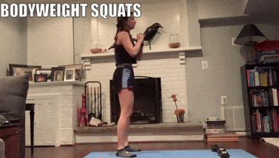 woman demonstrating bodyweight squats