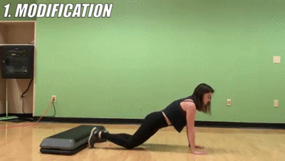 woman demonstrating modified plank taps