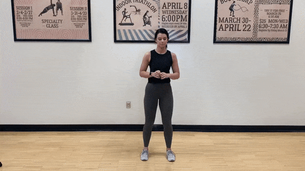 female demonstrating curtsy lunge squat