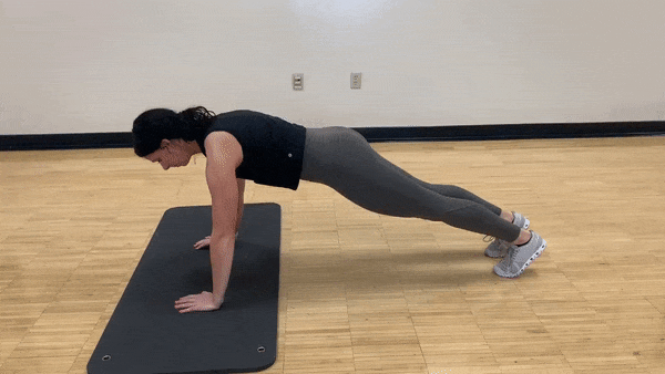 female demonstrating plank up down jack