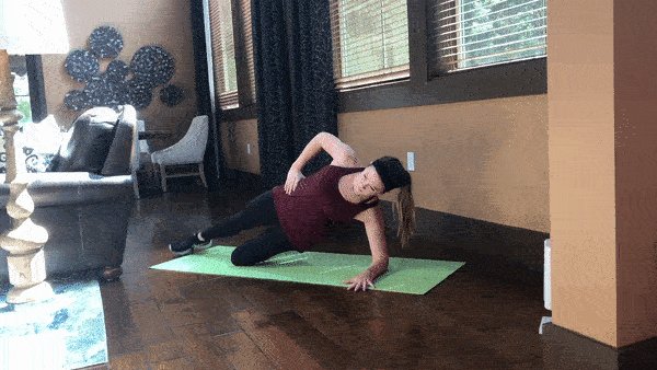 woman demonstrating side plank with leg lift