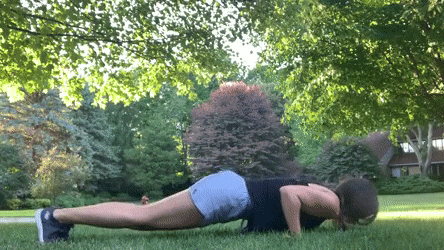 woman demonstrating push up pulse burnout