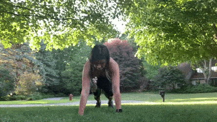 woman demonstrating side to side push ups