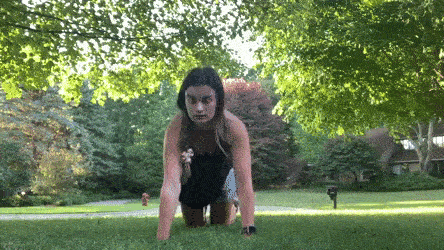 woman demonstrating side to side push up modification