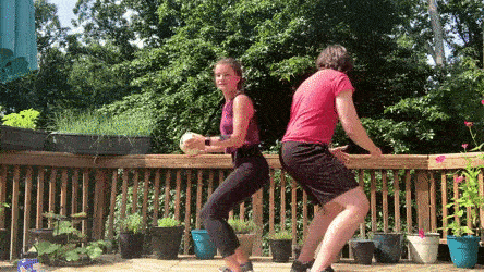 female and male demonstrating squat rotational pass modification