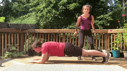 female and male demonstrating plank hold partner tuck jump over