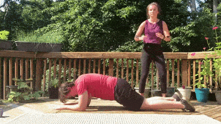 female and male demonstrating plank hold partner tuck jump over modification