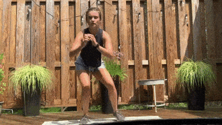 female demonstrating squat jump lunge