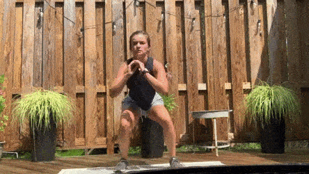 female demonstrating squat jump lunge modification