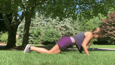 female demonstrating pushup with plank jack modification
