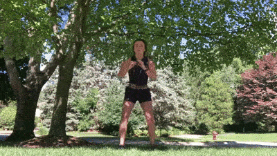 female demonstrating rotational squat with tuck modification