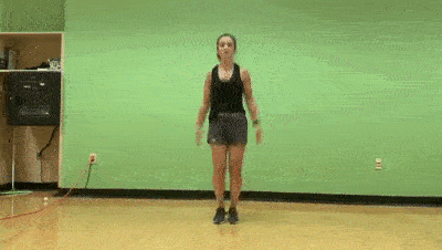 female demonstrating jumping jacks